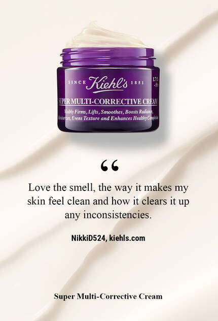 A jar of Kiehl's Super Multi-Corrective Cream on a smooth, cream-colored background, accompanied by a user testimonial praising its pleasant scent and skin-cleansing properties.