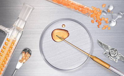 An assortment of laboratory tools and substances, including a glass vial with orange crystals, a petri dish with a drop of golden liquid, and a small spoon, arranged on a silver background, with a Kiehl's emblem.