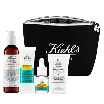 A black zippered pouch with the Kiehl's logo, containing four skincare products: a deep cleansing gel, a face cream, a serum, and a daily moisturizer.