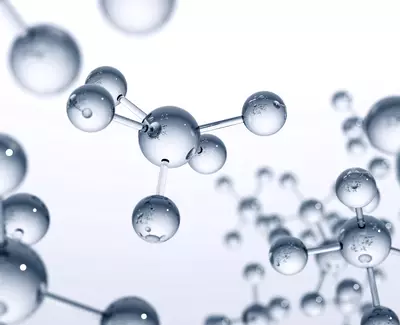 A close-up view of interconnected transparent molecules with a clean, minimalist background, emphasizing their spherical shapes and the presence of droplets on their surfaces.