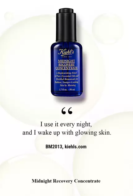 A dark blue bottle of Kiehl's Midnight Recovery Concentrate is displayed against a light background, accompanied by a quote about its nightly use for glowing skin.