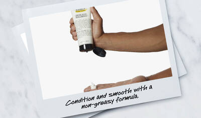 A hand holds a bottle of hair conditioner with a small amount of product being dispensed onto another hand. The text below reads, "Condition and smooth with a non-greasy formula."