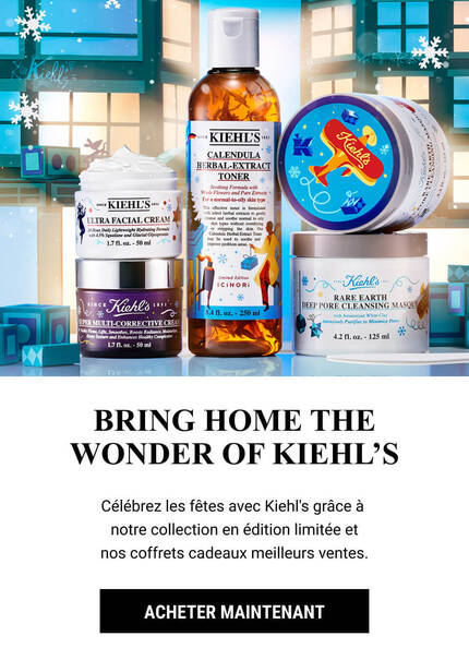 A festive display featuring Kiehl's limited edition holiday skincare products, including lotions and creams, set against a wintry backdrop with snowflakes and festive decorations.