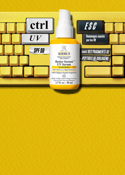 Une banniere publicitaire jaune pour le nouveau serum UV Better Screen SPF50 de Kiehl's. A gauche, le produit est pose sur un clavier d'ordinateur jaune dont les touches sont personnalisees avec les mentions « ctrl UV », « ESC SCHADE » et « SPF 50 ». Au centre, on peut lire : « NIEUW! BETTER SCREEN UV SERUM SPF50 » suivi d'une description du produit et d'un bouton « SHOP NU ». A droite figurent un curseur de souris en pixel-art et le sceau de la Skin Cancer Foundation.