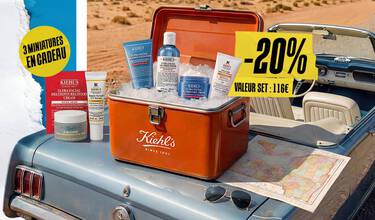 Set Kiehl's Oil-Free Essentials dans une glaciere vintage sur une voiture bleue, entoure de glace et d'une carte.