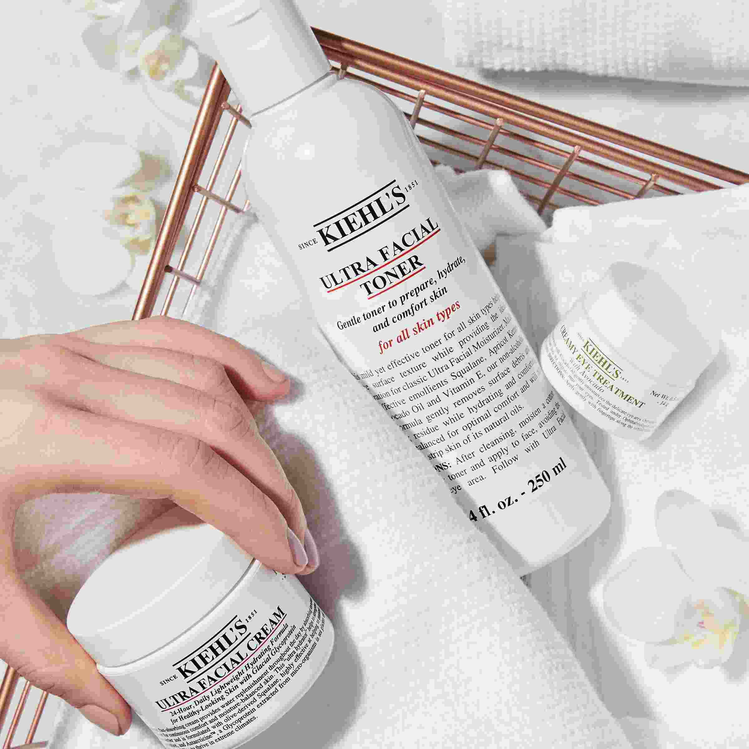 Kiehl's Ultra Facial Toner, described as an "Ultra- Lightweight Milky Toner," is being poured, highlighting its texture.​