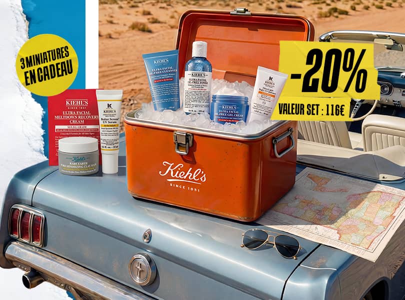 Set Kiehl's Oil-Free Essentials dans une glacière vintage sur une voiture bleue, entouré de glace et d'une carte.